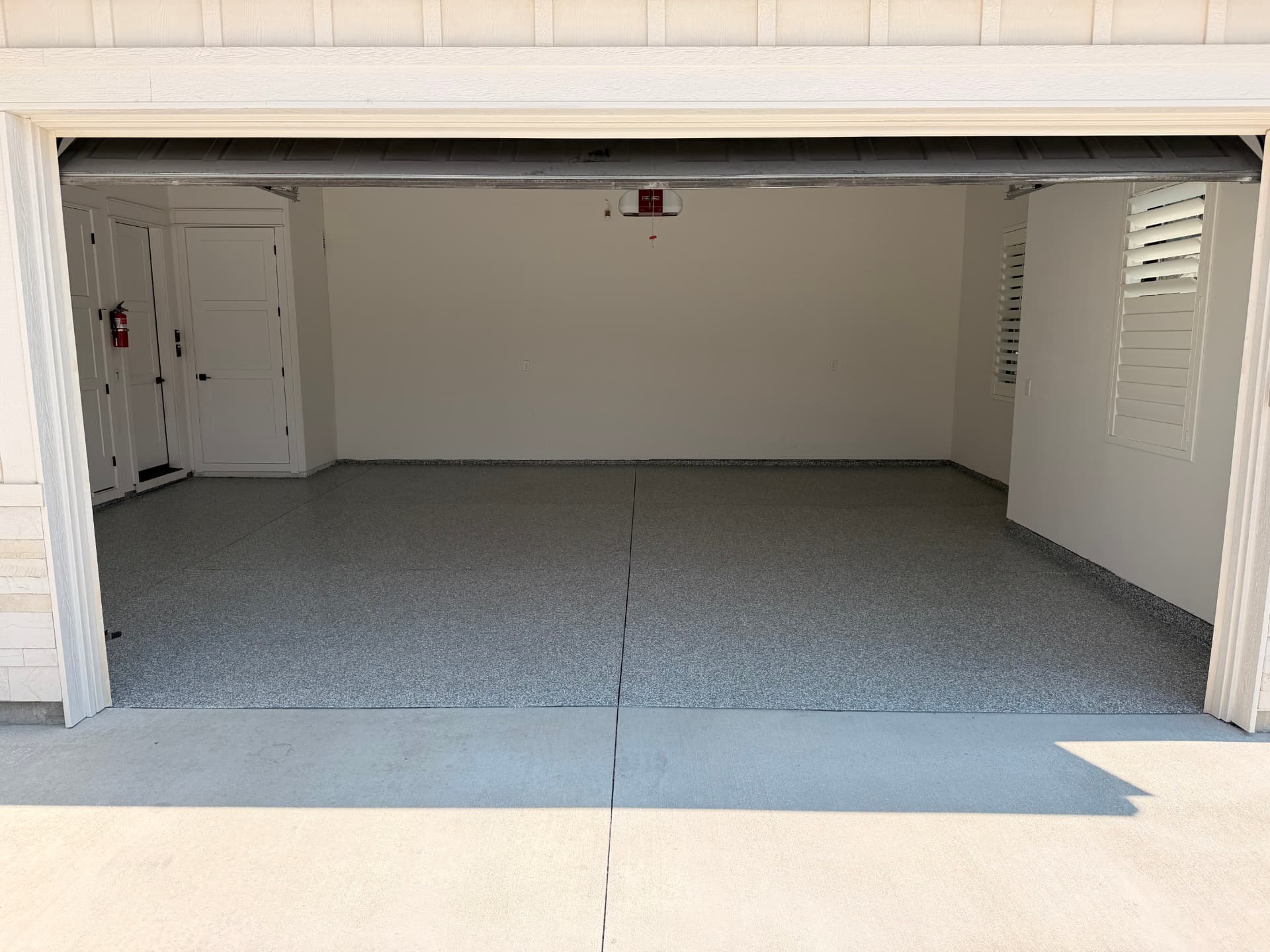 Residential garage floor after installation, finished with Stonehenge flake polyaspartic coating